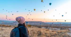 Girl looking at hot air balloons